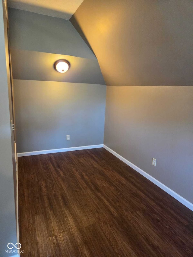 2819 W 16th St, Indianapolis, IN 46222 - additional living space with baseboards, dark wood-style flooring, and lofted ceiling