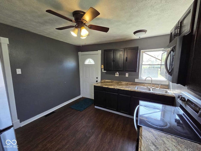 2819 W 16th St, Indianapolis, IN 46222 - kitchen featuring a sink, stainless steel appliances, dark wood-style flooring, and a textured ceiling