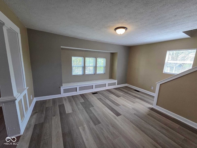 2819 W 16th St, Indianapolis, IN 46222 - spare room featuring a textured ceiling, baseboards, visible vents, and wood finished floors