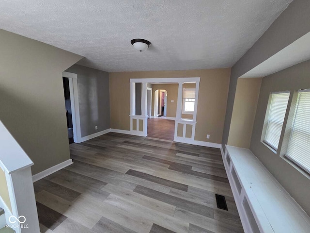 2819 W 16th St, Indianapolis, IN 46222 - interior space featuring baseboards, a textured ceiling, visible vents, and wood finished floors