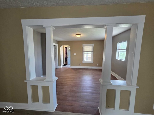2819 W 16th St, Indianapolis, IN 46222 - interior space with baseboards, arched walkways, and wood finished floors