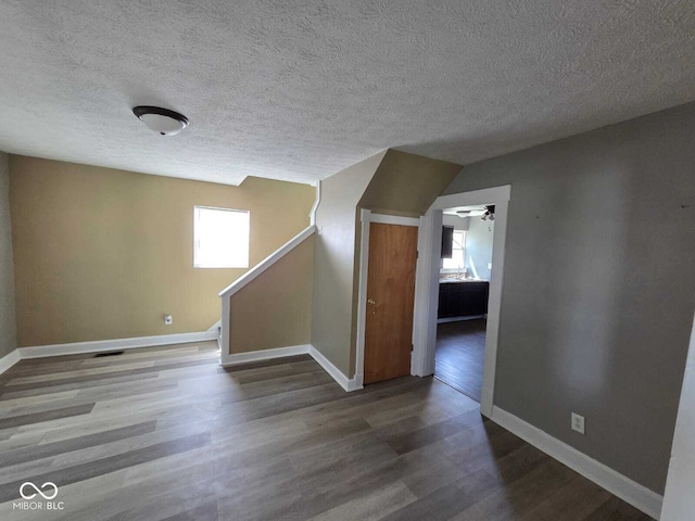 2819 W 16th St, Indianapolis, IN 46222 - bonus room with a textured ceiling, a ceiling fan, baseboards, wood finished floors, and stairway
