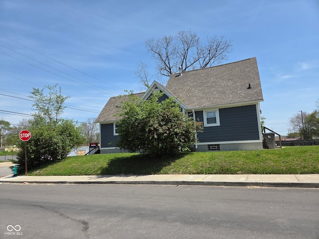 2819 W 16th St, Indianapolis, IN 46222 - view of front facade with a shingled roof and a front lawn