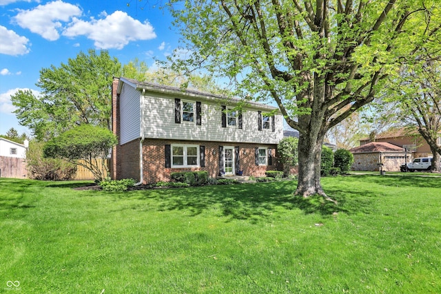 12669 Brookshire Pkwy, Carmel, IN 46033 - colonial inspired home featuring fence, a chimney, a front lawn, and brick siding