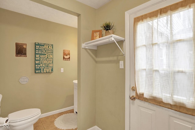 12669 Brookshire Pkwy, Carmel, IN 46033 - half bathroom featuring tile patterned flooring, baseboards, and toilet