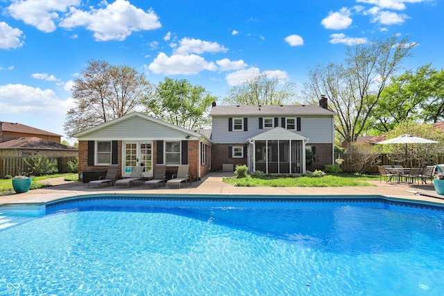 12669 Brookshire Pkwy, Carmel, IN 46033 - view of swimming pool with fence, a fenced in pool, a patio area, and a sunroom