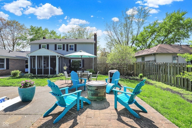 12669 Brookshire Pkwy, Carmel, IN 46033 - view of patio / terrace with outdoor dining area, a fenced backyard, a sunroom, and an outdoor fire pit