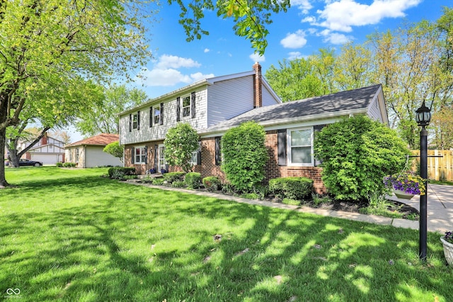 12669 Brookshire Pkwy, Carmel, IN 46033 - colonial inspired home featuring brick siding, fence, a chimney, and a front yard