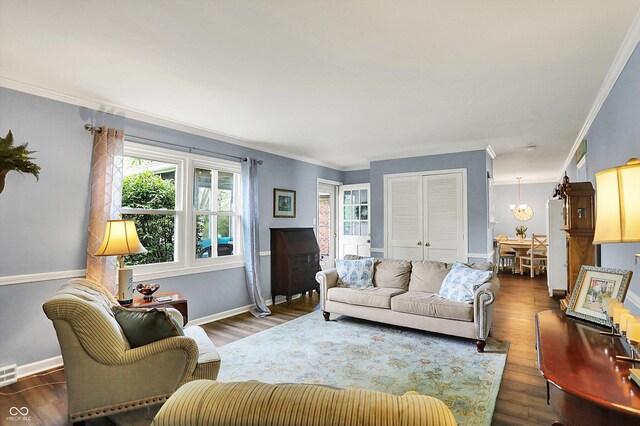 12669 Brookshire Pkwy, Carmel, IN 46033 - living room with visible vents, ornamental molding, baseboards, and wood finished floors