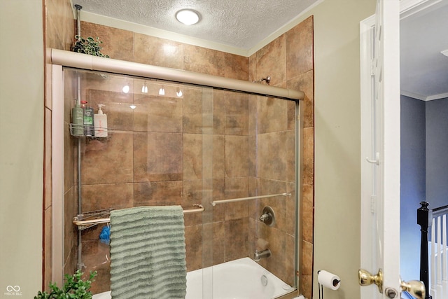 12669 Brookshire Pkwy, Carmel, IN 46033 - full bathroom featuring combined bath / shower with glass door and a textured ceiling