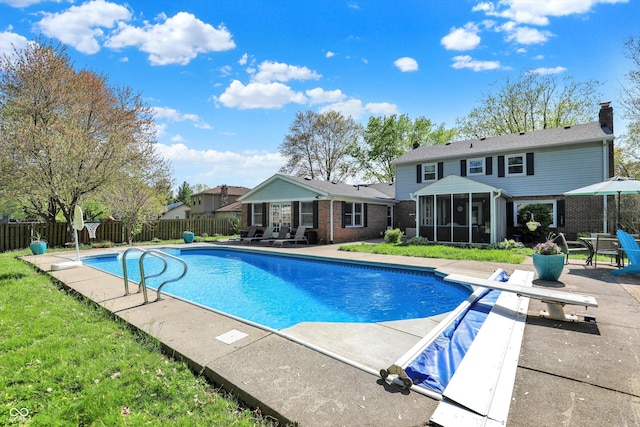 12669 Brookshire Pkwy, Carmel, IN 46033 - view of pool with fence, a diving board, a sunroom, a fenced in pool, and a patio area