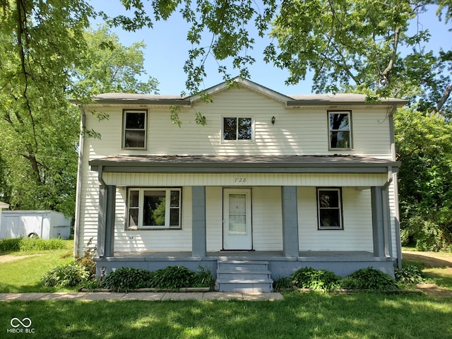 view of front of property with covered porch and a front lawn
