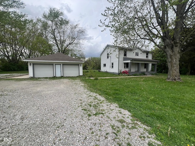 728 W 300 N, Anderson, IN 46011 - view of front of house featuring covered porch, an outbuilding, a front lawn, and a detached garage