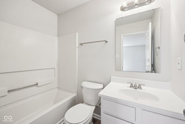 full bath with vanity, toilet, a textured ceiling, and shower / tub combination
