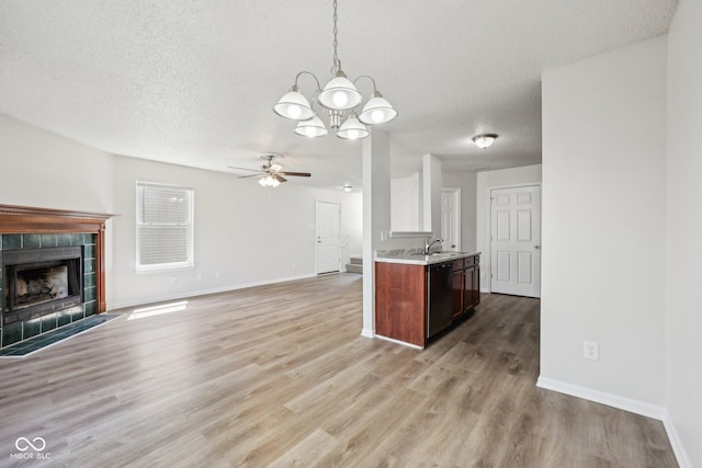 kitchen featuring light countertops, a textured ceiling, ceiling fan with notable chandelier, and dishwasher