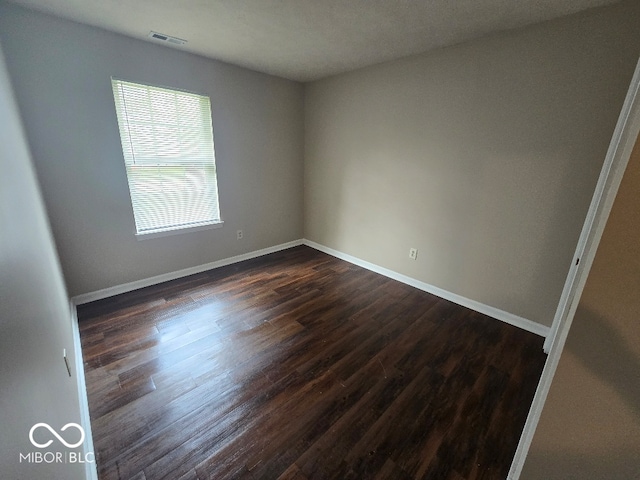 9118 Lansburgh Ct, Indianapolis, IN 46234 - spare room featuring baseboards and dark wood-style flooring