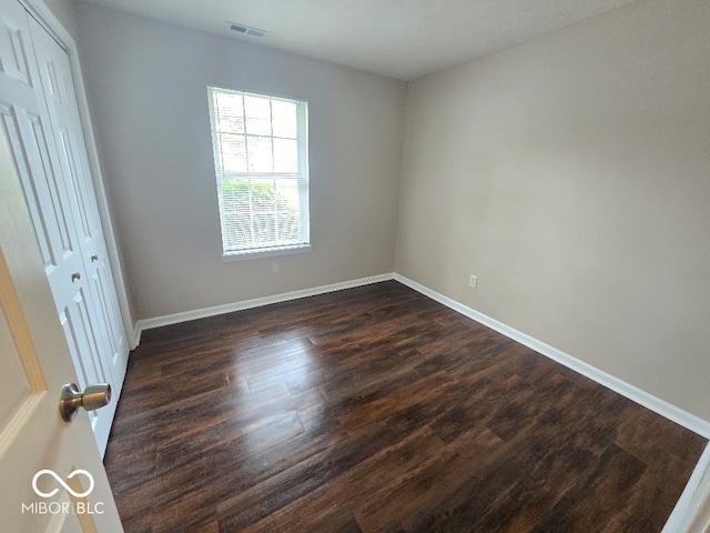 9118 Lansburgh Ct, Indianapolis, IN 46234 - spare room with baseboards, visible vents, and dark wood-style flooring