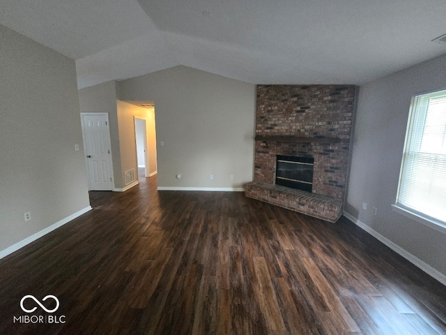 9118 Lansburgh Ct, Indianapolis, IN 46234 - unfurnished living room with baseboards, lofted ceiling, dark wood-style floors, and a fireplace