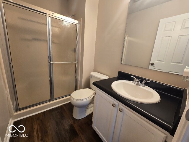 9118 Lansburgh Ct, Indianapolis, IN 46234 - bathroom with a shower stall, toilet, vanity, and wood finished floors