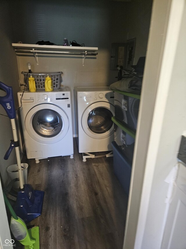 washroom with washer and dryer, wood finished floors, and electric panel