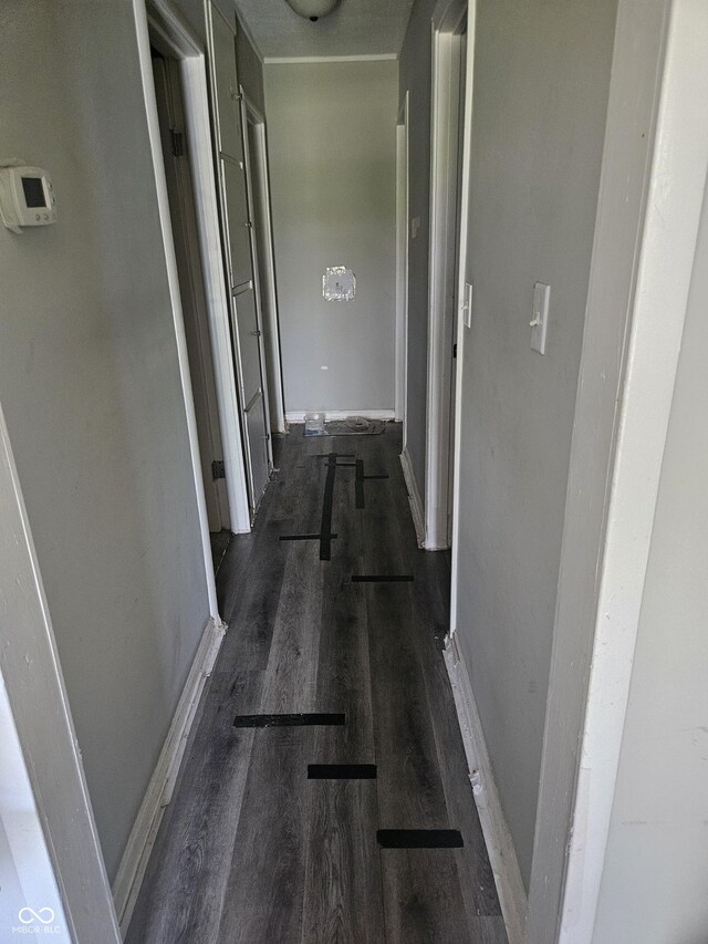 hall with dark wood finished floors and baseboards