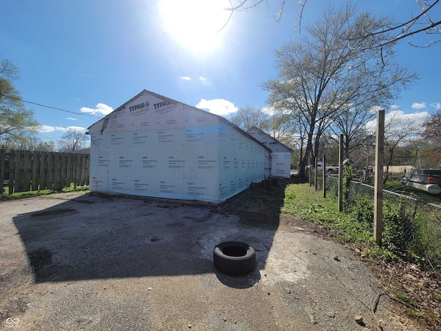 view of outbuilding featuring fence