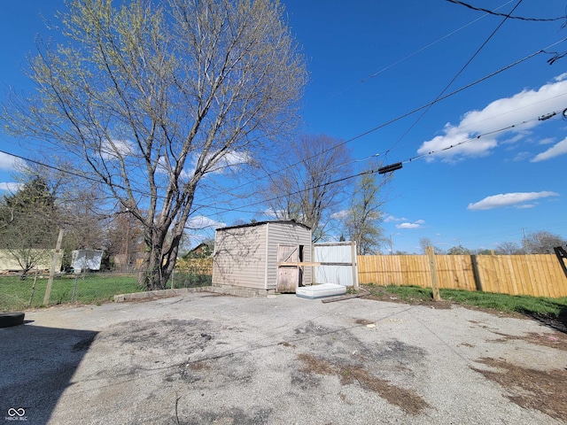 view of yard featuring an outdoor structure and fence