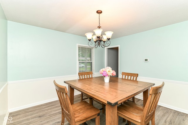 7140 Avalon Trail Dr, Indianapolis, IN 46250 - dining room with a chandelier, light wood-style flooring, and baseboards