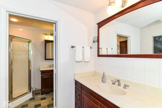 7140 Avalon Trail Dr, Indianapolis, IN 46250 - bathroom with a stall shower, vanity, and tasteful backsplash