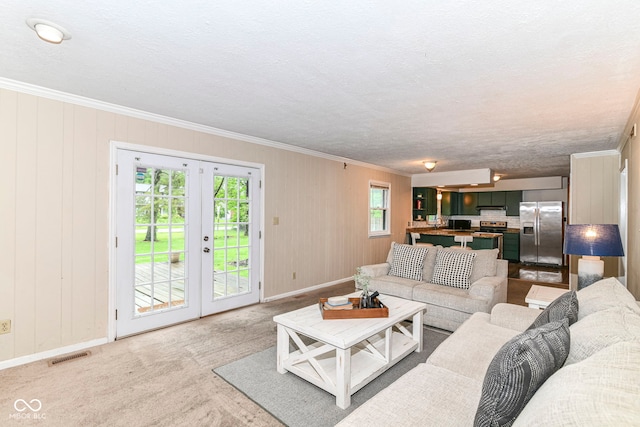 7140 Avalon Trail Dr, Indianapolis, IN 46250 - living room with crown molding, baseboards, french doors, and carpet flooring