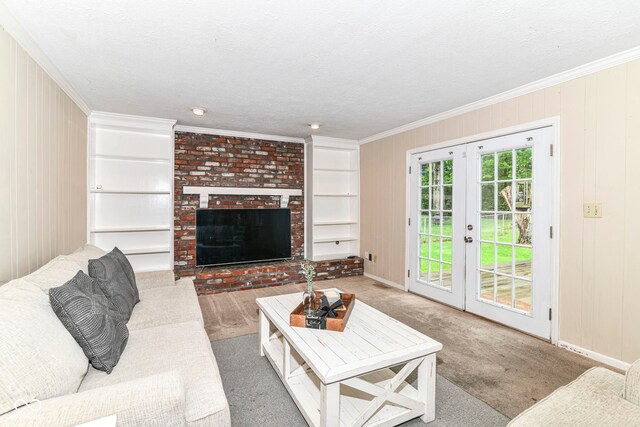 7140 Avalon Trail Dr, Indianapolis, IN 46250 - carpeted living room featuring crown molding, a fireplace, french doors, baseboards, and built in shelves