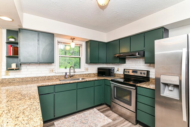 7140 Avalon Trail Dr, Indianapolis, IN 46250 - kitchen featuring stainless steel appliances, a sink, under cabinet range hood, open shelves, and a textured ceiling