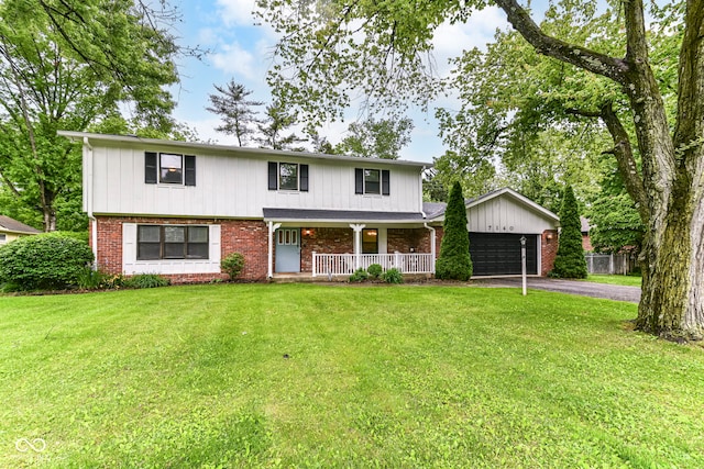 7140 Avalon Trail Dr, Indianapolis, IN 46250 - traditional-style home with a porch, driveway, an attached garage, a front lawn, and brick siding