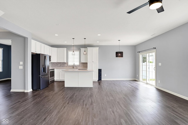 6827 Fallen Leaf Dr, Whitestown, IN 46075 - kitchen with refrigerator with ice dispenser, stainless steel range with electric cooktop, open floor plan, plenty of natural light, and recessed lighting