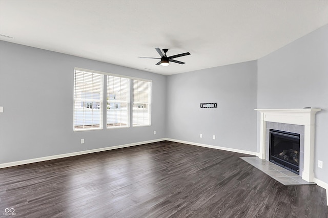 6827 Fallen Leaf Dr, Whitestown, IN 46075 - unfurnished living room with a ceiling fan, dark wood-type flooring, and a tiled fireplace