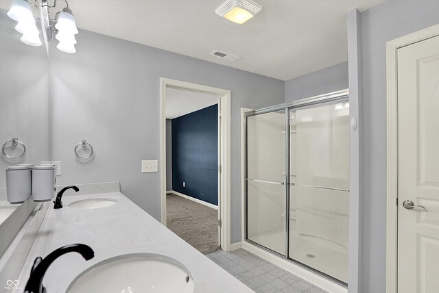 6827 Fallen Leaf Dr, Whitestown, IN 46075 - bathroom with a stall shower, a chandelier, double vanity, and tile patterned flooring