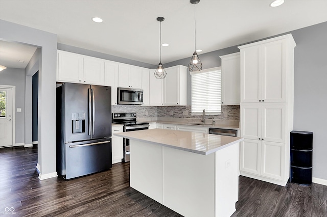 6827 Fallen Leaf Dr, Whitestown, IN 46075 - kitchen with appliances with stainless steel finishes, dark wood-style flooring, decorative backsplash, a center island, and recessed lighting