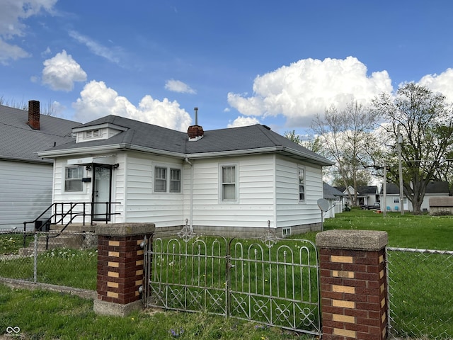 3434 Forrest Ter, Anderson Se, IN 46013 - exterior space featuring a gate, a yard, a shingled roof, and a fenced front yard