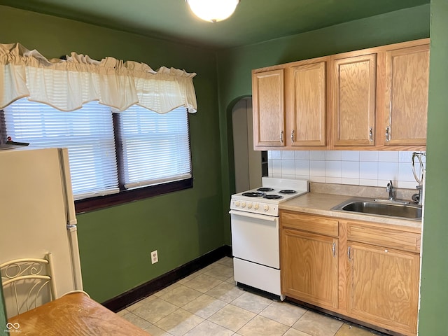 3434 Forrest Ter, Anderson Se, IN 46013 - kitchen featuring arched walkways, light brown cabinets, light tile patterned floors, electric range, and a sink