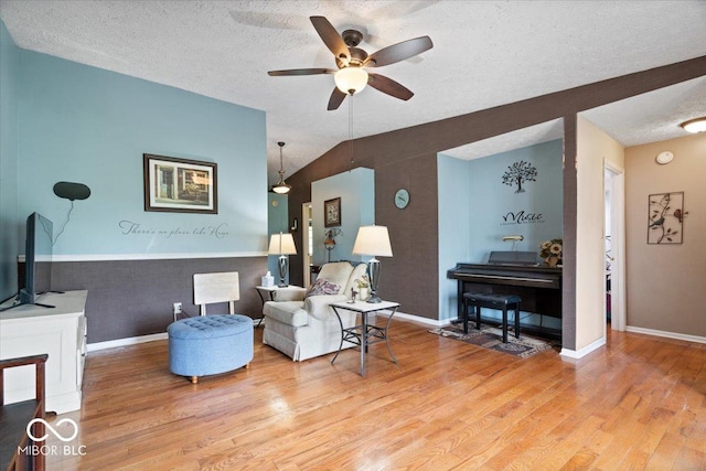 sitting room featuring baseboards, a ceiling fan, a textured ceiling, and light wood finished floors