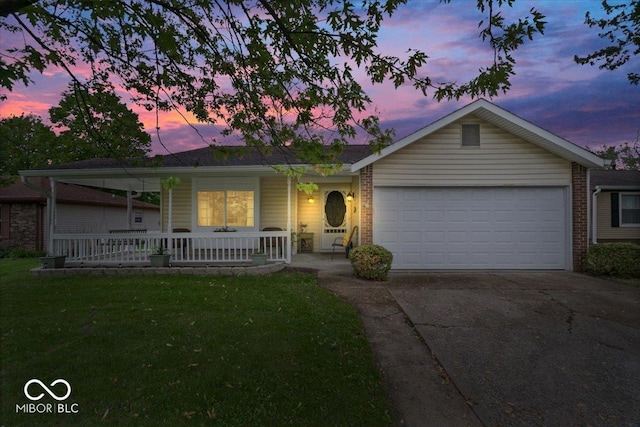ranch-style home with an attached garage, brick siding, a front yard, covered porch, and driveway