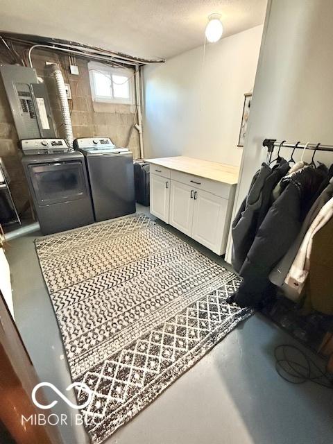 laundry room with washing machine and dryer and cabinet space