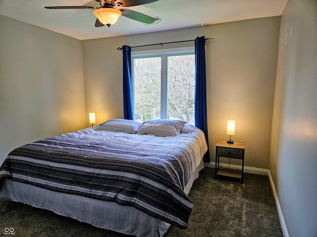 carpeted bedroom featuring baseboards and ceiling fan