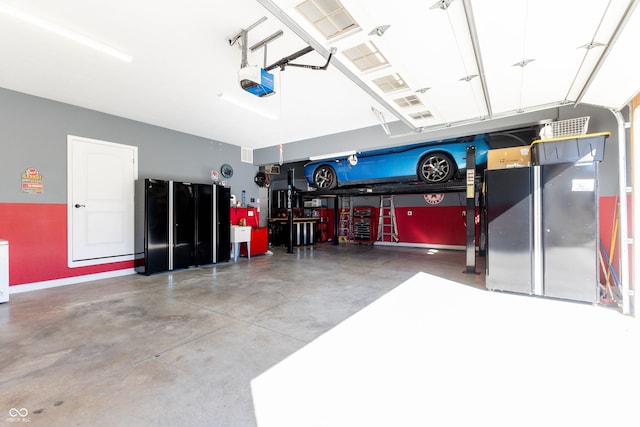 garage with baseboards and a garage door opener