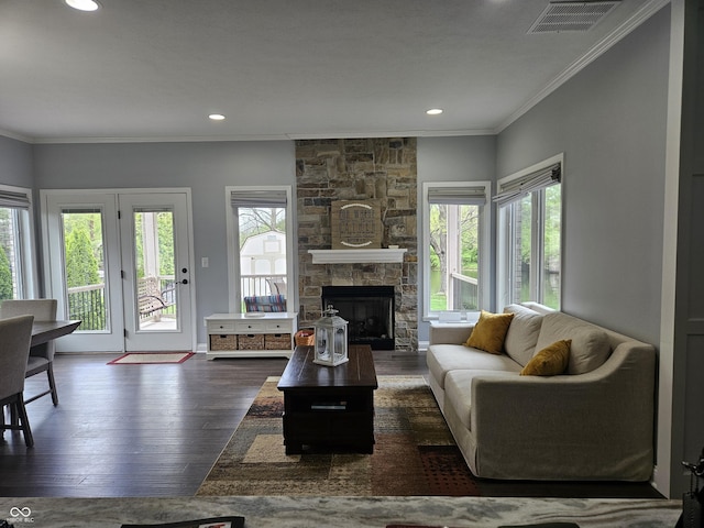 living room featuring visible vents, crown molding, wood finished floors, a fireplace, and recessed lighting