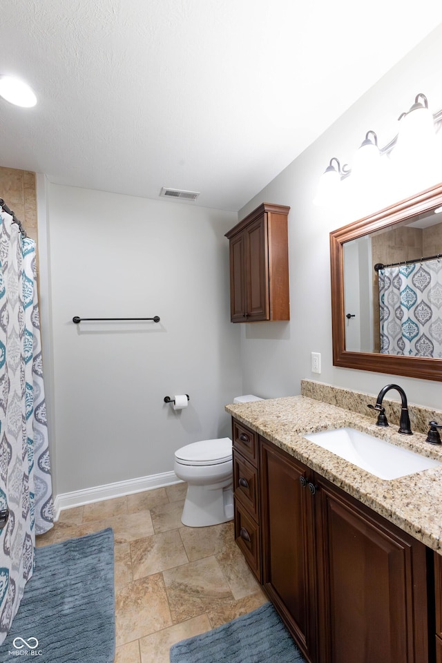 bathroom with visible vents, vanity, toilet, baseboards, and a shower with shower curtain