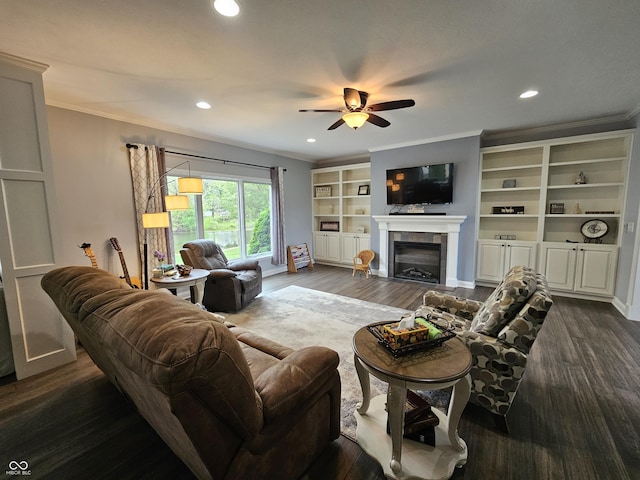 living area with crown molding, ceiling fan, a fireplace, and recessed lighting