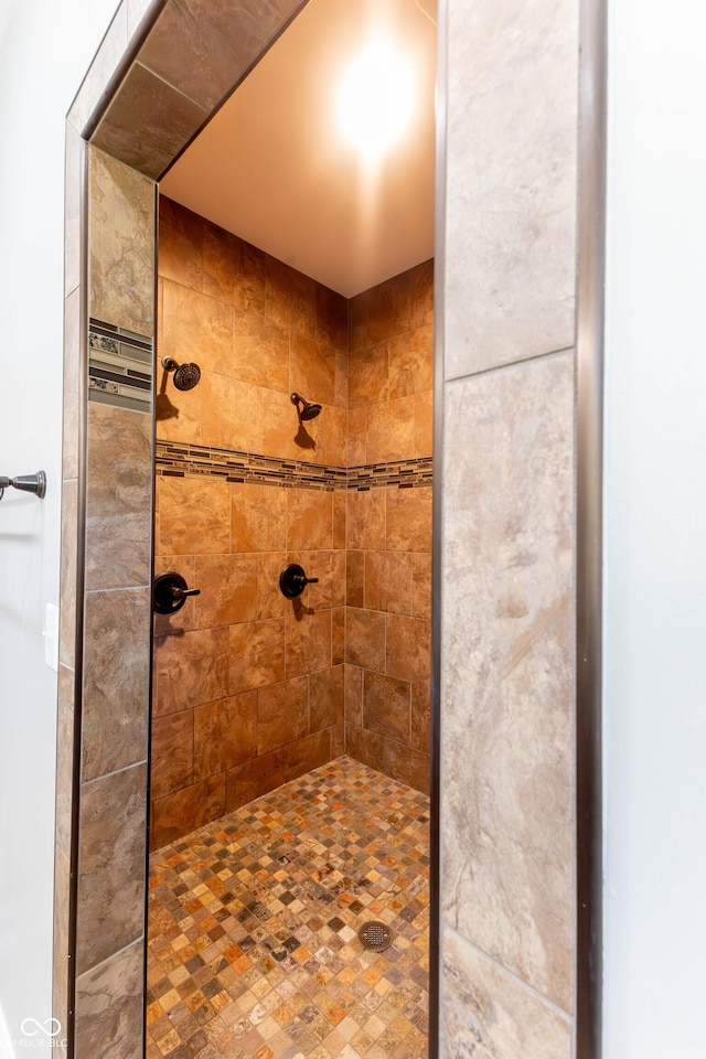 bathroom with tiled shower
