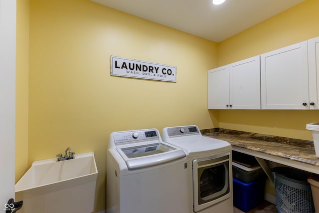 laundry room featuring a sink, cabinet space, and washer and clothes dryer