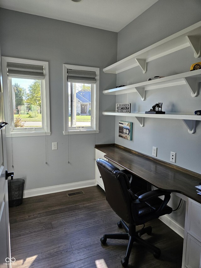 office space with baseboards, dark wood finished floors, and visible vents